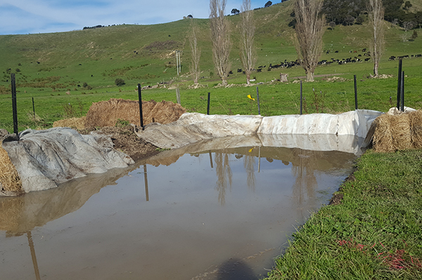 A small constructed pond with old sack material lining the sides.